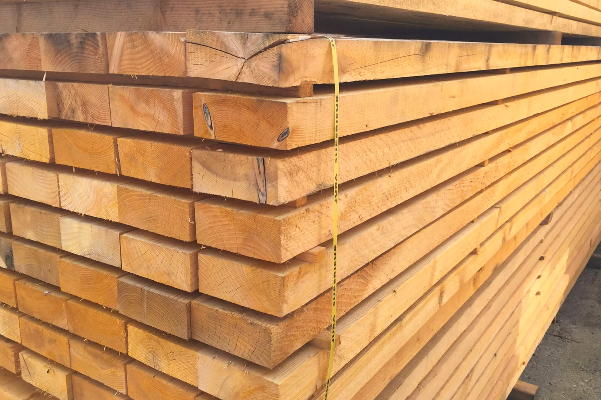 Bois bruts, bastaings, chevrons, madriers, plinthes rouges et garde corps rouge.